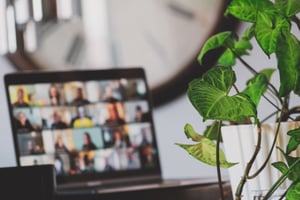 Decorative image of blurred video meeting on laptop screen